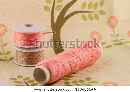 Pink thread on spring themed fabric. Fabric my own design.