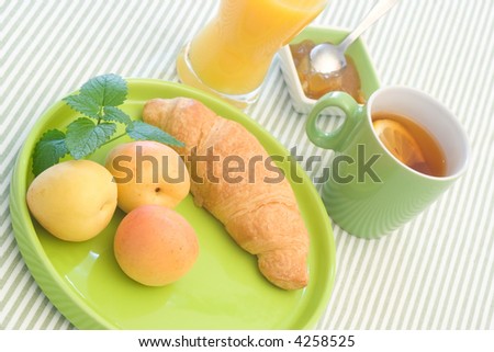 Yellow breakfast food on green tableware