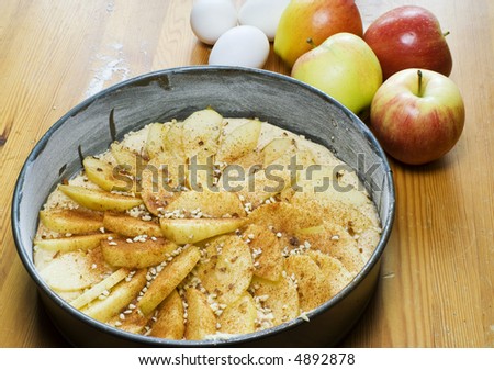 An apple pie on a rustic table ready for the oven