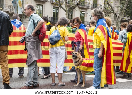 BARCELONA, SPAIN - SEPTEMBER 11: People and dog joining the human chain \