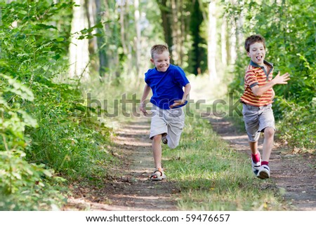 Young children running in nature
