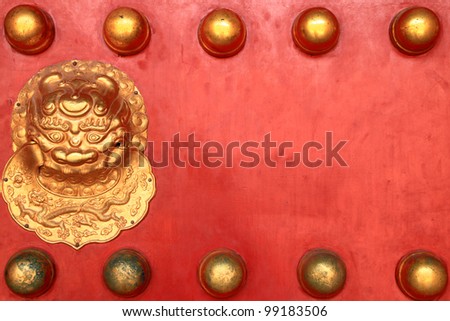 Chinese traditional designs(Qing dynasty style) red door with dragon head knob in forbidden city, Beijing, China.