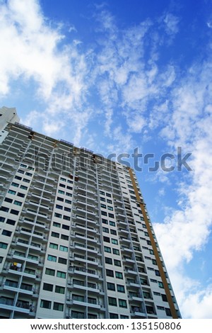 Apartment building against blue sky background