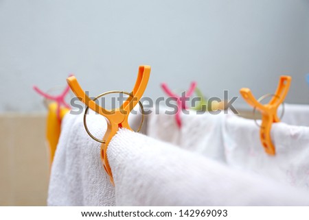Colorful clothes pegs on clothes line