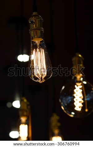 electric lamps hanging on the ceiling in the dark room
