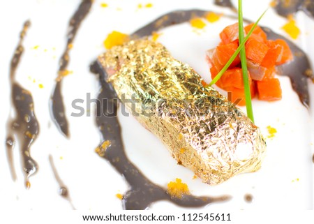 sea food : roasted wild salmon , gold sauce on white dish