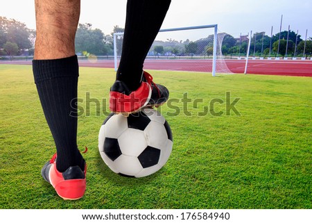 rear view soccer player\'s feet in casual pose on the field