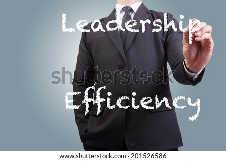 businessman writing leadership efficiency word on the screen by white chalk in business concept