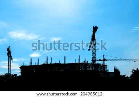 construction site silhouetted on daytime blue sky