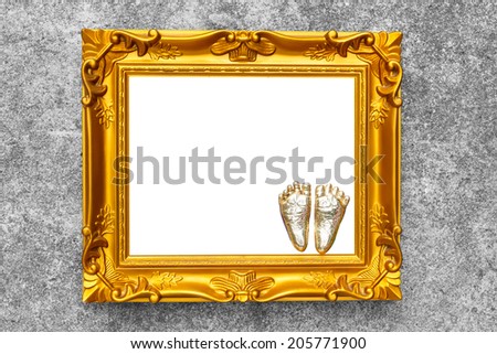 antique golden frame imprint of the child foot on concreate wall vintage