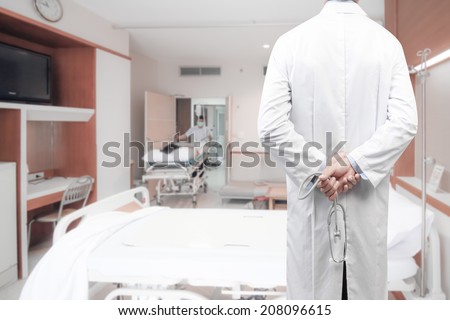 rear view image of doctors with stethoscope pose arms crossed behind back looking at male nurse pushing stretcher gurney bed & patient  into room of hospital