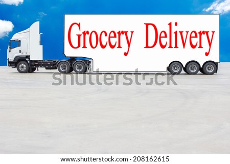 commercial delivery cargo truck and word grocery delivery against blue sky background