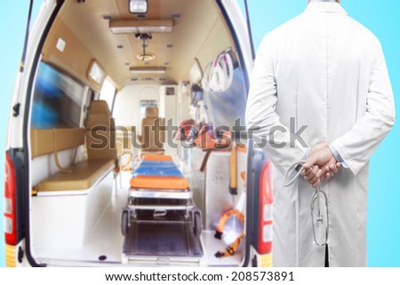 rear view image of doctors with stethoscope pose arms crossed behind back looking at Inside of an ambulance for the hospital