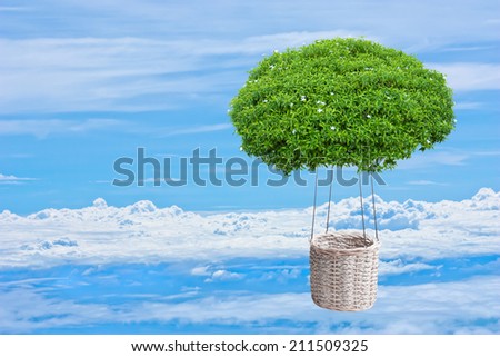ornamental bush tree hot air fantasy balloon basket floating over the cloud against blue sky background in ecology concept