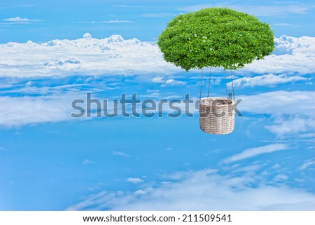 ornamental bush tree hot air fantasy balloon basket floating over the cloud against bright blue sky background in ecology concept