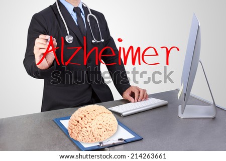 doctor writing word alzheimer on virtual screen and using computer worker at desk