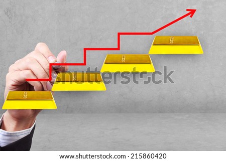 business hand and graph with rising arrow gold bars idea success business on transparent glass idea concept for success and growth