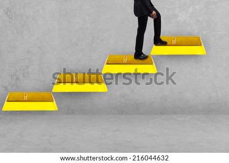 business man walking up gold bars stepping ladder idea concept for success and growth