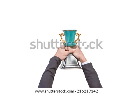 Business hand holding a champion trophy isolated on white background with clipping path