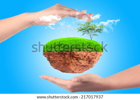 Little island with wind turbines and trees in the hands protection
