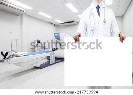doctors holding a white blank banner at computed tomography or computed axial tomography scan machine in hospital room
