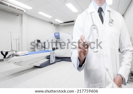 doctor writing something in the air at computed tomography or computed axial tomography scan machine in hospital room