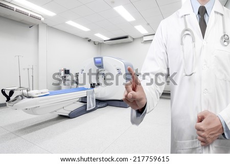 doctors hand touching virtual screen for presenting at computed tomography or computed axial tomography scan machine in hospital room