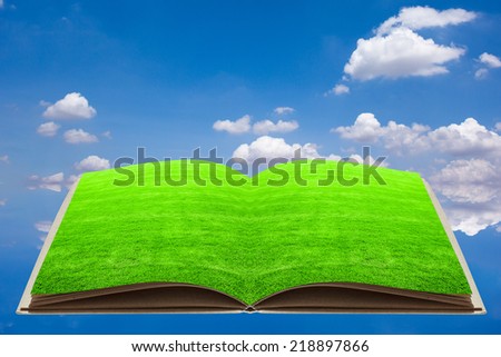 open recycled note book over blue sky in ecology concept