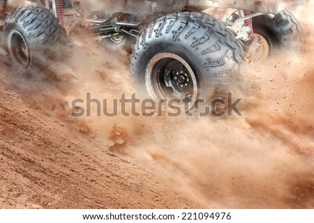 Detailed view of motion the wheels tires and off-road truck shaft that goes in the dust of the desert  through the wheels on the sand