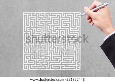 business hand finding solution of maze