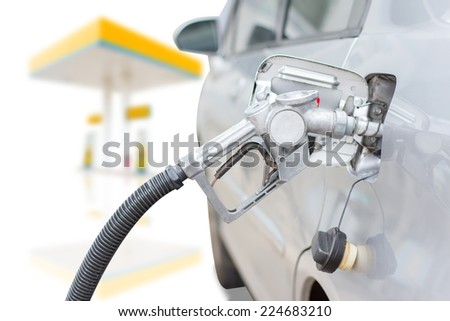 classic fuel nozzle pumping a benzine fuel liquid refilling the car at gas station