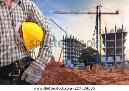 civil engineer working in building construction site and sunset sky with crane construction