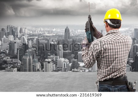 engineer working at building construction site against urban scene balcony over looking city dusky before rain falling