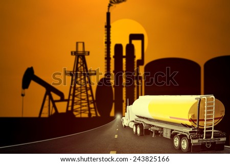 Truck with fuel tank on the highway into oil rig and beautiful sunset sky in concept of industrial petrochem