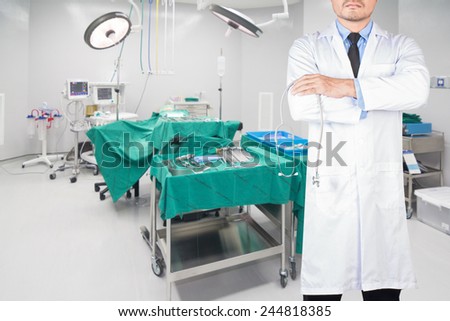 doctors with stethoscope pose arms crossed behind back at operating room in a modern hospital