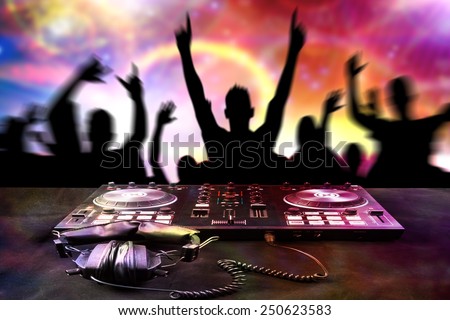 DJ mixes the track turntable to play music dance and crowd in nightclub at party