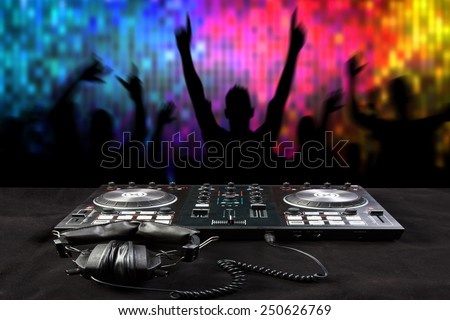 Disc Jockey mixes the track turntable to play music dance and crowd in nightclub at party