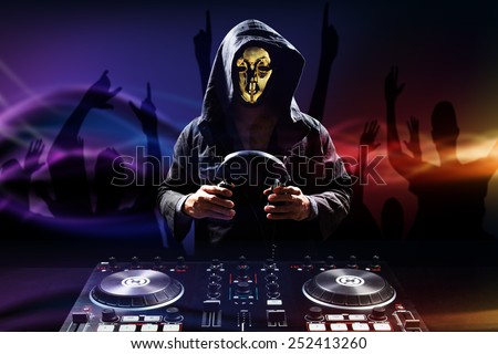 Anonymous disc jockey mixes the track turntable to play music dance and crowd in nightclub at party