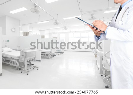 doctor writing clipboard for diagnosis in aided the recovery room with modern equipment and comfortable equipped in hospital