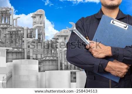 mechanic maintaining record at petrochemical Industrial plant with blue sky