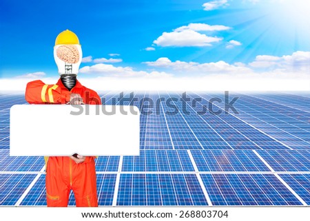 technician have brain inside a light bulb in uniform holding toolbox blank for work space and solar energy panels against beautiful sky with in concept ecology