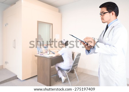 doctor writing clipboard for diagnosis in audiologist testing hearing by medical equipment room