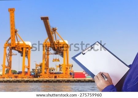 dock worker recording controlling work process in the harbor