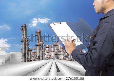 Engineer writing process for working at petrochemical oil refinery against beautiful sky
