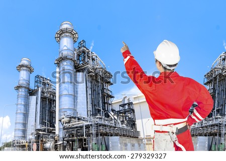 Engineer control working at equipments and machinery with modern thermal power plant in refinery