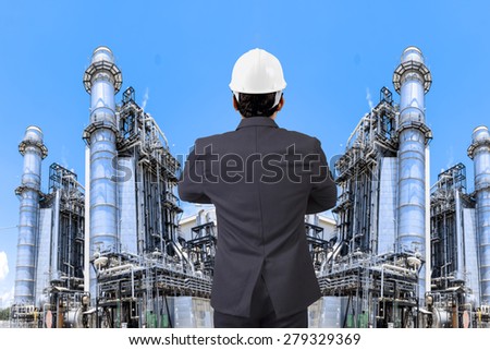 Engineer working at equipments and machinery with modern thermal power plant in refinery