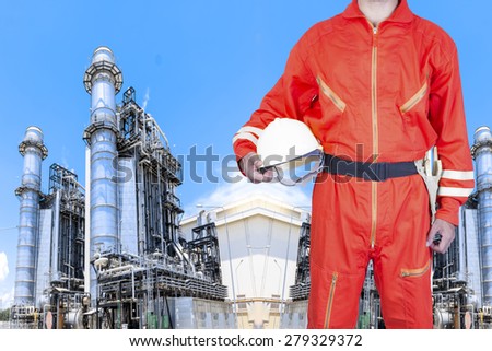 Engineer holding hard hat at equipments and machinery with modern thermal power plant in refinery