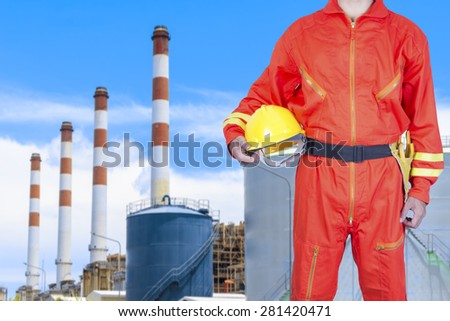 Engineer holding helmet for working at modern thermal power plants