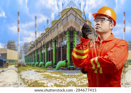 Technician with radio communication in action for working at cooling tower of Industrial power plant