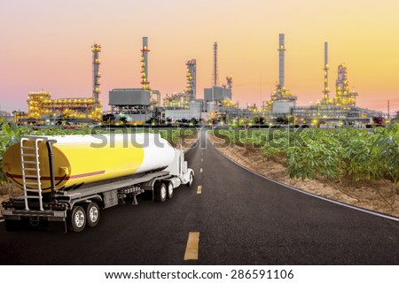 Tanker truck for transport fuel on the highway to petrochemical oil refinery in sunrise